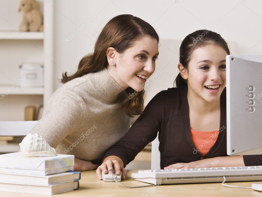 depositphotos 18779753 stock photo mother on daughter on computer