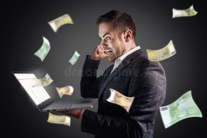 Businessman rejoices at money flying from a laptop. Concept online earnings, gambling, freelance.  royalty free stock photography