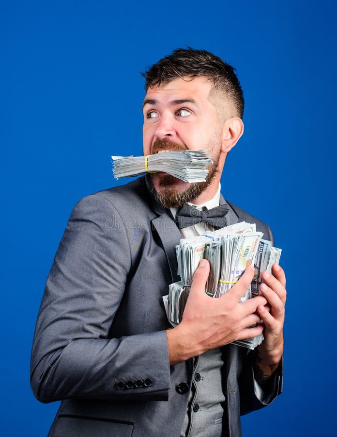 Businessman surprised feels like thief with lot of cash in hands. Steal money. Thief with piles dollars money. Earnings. Surprise concept. Man bearded royalty free stock photos