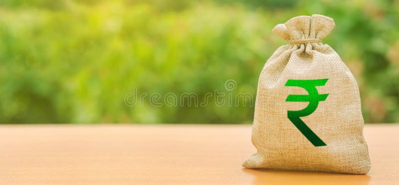 Indian rupee money bag on nature background. Profit, income, earnings. Finance and budgeting, investments, bank deposit interest. Rates. Economics, salary stock image