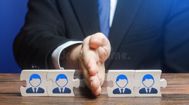 A man divides puzzle team of employees. Team split, structural fragmentation into small units. Improving company efficiency. Staff. Dismissal reduction stock photos