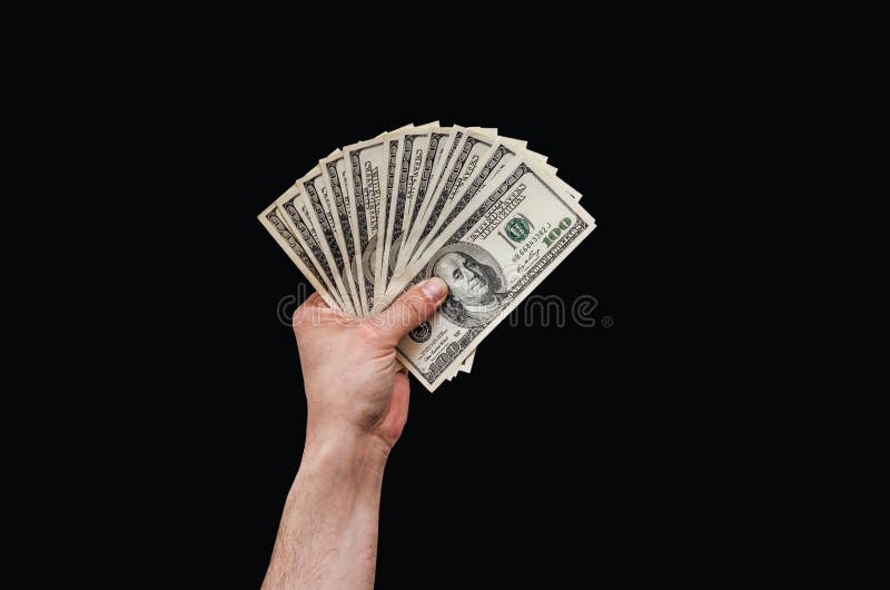 Man hand holds american dollars money. On black background. Finance, earnings, crediting.  royalty free stock photography